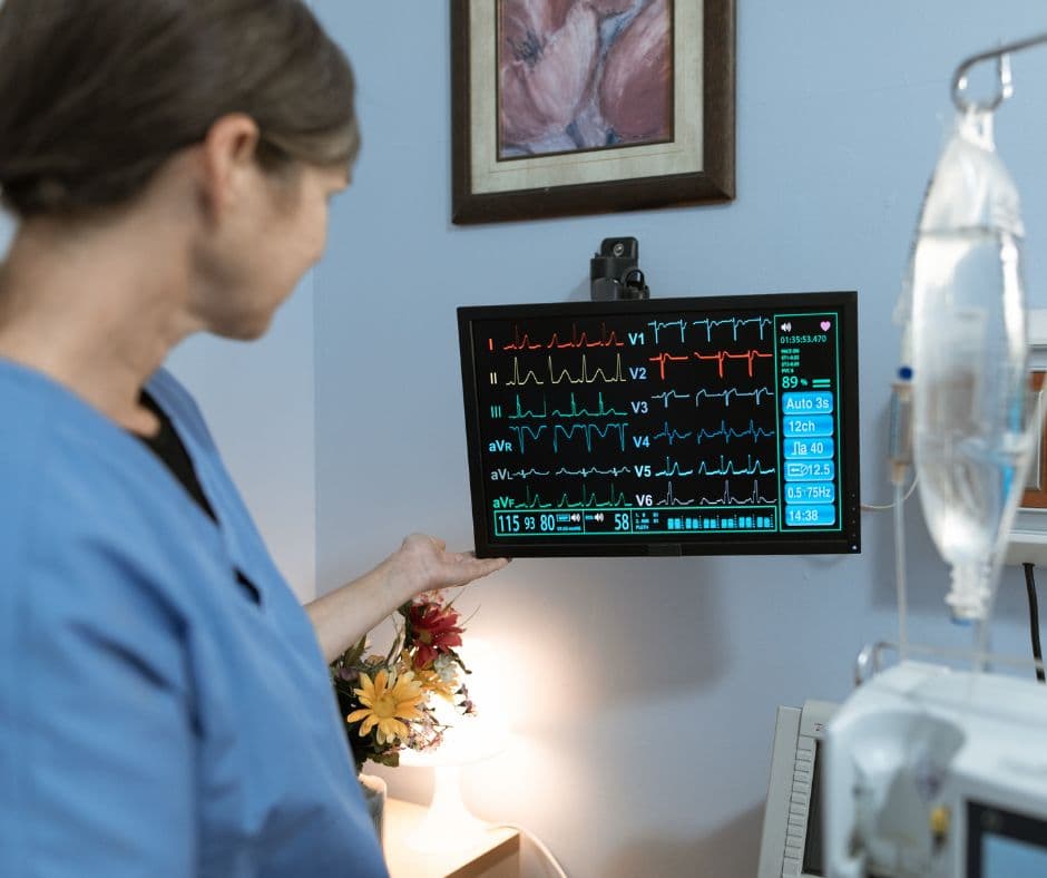 Clinician monitoring cardiovascular readings during specialty care