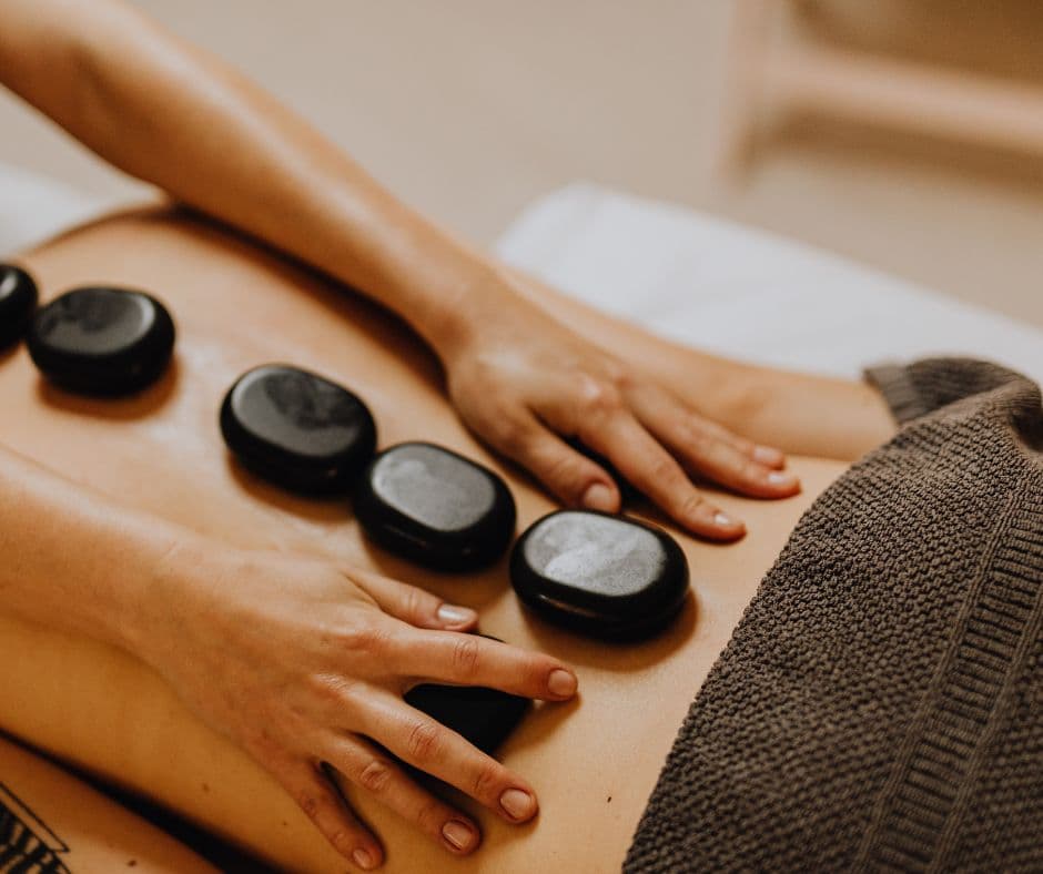 Patient receiving a hot stone wellness treatment